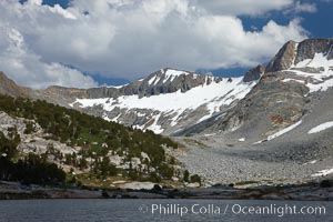 Townsley Lake, a beautiful alpine lake sitting below blue sky, clouds and Fletcher Peak (right), lies amid the Cathedral Range of glacier-sculpted granite peaks in Yosemite's high country, near Vogelsang High Sierra Camp, Yosemite National Park, California