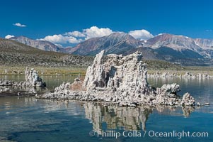 Tufa towers rise from Mono Lake with the Eastern Sierra visible in the distance.  Tufa towers are formed when underwater springs rich in calcium mix with lakewater rich in carbonates, forming calcium carbonate (limestone) structures below the surface of the lake.  The towers were eventually revealed when the water level in the lake was lowered starting in 1941.  South tufa grove, Navy Beach