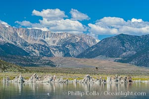 Tufa towers rise from Mono Lake with the Eastern Sierra visible in the distance.  Tufa towers are formed when underwater springs rich in calcium mix with lakewater rich in carbonates, forming calcium carbonate (limestone) structures below the surface of the lake.  The towers were eventually revealed when the water level in the lake was lowered starting in 1941.  South tufa grove, Navy Beach