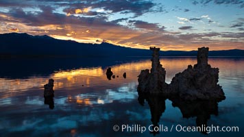 Tufa towers rise from Mono Lake, with the Eastern Sierra visible in the distance. Tufa towers are formed when underwater springs rich in calcium mix with lakewater rich in carbonates, forming calcium carbonate (limestone) structures below the surface of the lake. The towers were eventually revealed when the water level in the lake was lowered starting in 1941