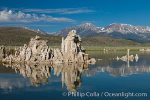 Tufa towers rise from Mono Lake, with the Eastern Sierra visible in the distance. Tufa towers are formed when underwater springs rich in calcium mix with lakewater rich in carbonates, forming calcium carbonate (limestone) structures below the surface of the lake. The towers were eventually revealed when the water level in the lake was lowered starting in 1941