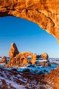 Sunrise light on Turret Arch viewed through North Window, winter, Arches National Park, Utah