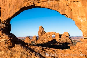 Turret Arch viewed through North Window at Sunrise, Arches National Park, Utah