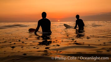 Two surfers at sunset, blood red dusk, Encinitas.