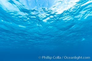 Sunlight and clouds are visible through the clear ocean waters of the Northern Bahamas