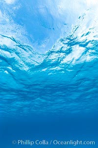 Sunlight and clouds are visible through the clear ocean waters of the Northern Bahamas