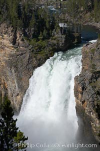 Hikers can be seen at the brink of the Upper Falls of the Yellowstone River, a 100 foot plunge at the head of the Grand Canyon of the Yellowstone, Yellowstone National Park, Wyoming