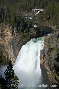 Hikers can be seen at the brink of the Upper Falls of the Yellowstone River, a 100 foot plunge at the head of the Grand Canyon of the Yellowstone, Yellowstone National Park, Wyoming