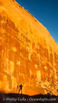 Rising sun creates the photographers shadow on a sandstone wall.