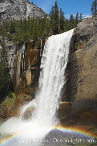 Vernal Falls at peak flow in late spring, with a rainbow appearing in the spray of the falls, viewed from the Mist Trail, Yosemite National Park, California