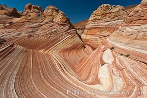 The Wave, an area of fantastic eroded sandstone featuring beautiful swirls, wild colors, countless striations, and bizarre shapes set amidst the dramatic surrounding North Coyote Buttes of Arizona and Utah.  The sandstone formations of the North Coyote Buttes, including the Wave, date from the Jurassic period. Managed by the Bureau of Land Management, the Wave is located in the Paria Canyon-Vermilion Cliffs Wilderness and is accessible on foot by permit only