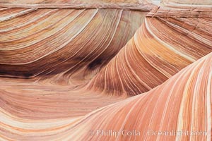 The Wave in the North Coyote Buttes, an area of fantastic eroded sandstone featuring beautiful swirls, wild colors, countless striations, and bizarre shapes set amidst the dramatic surrounding North Coyote Buttes of Arizona and Utah. The sandstone formations of the North Coyote Buttes, including the Wave, date from the Jurassic period. Managed by the Bureau of Land Management, the Wave is located in the Paria Canyon-Vermilion Cliffs Wilderness and is accessible on foot by permit only