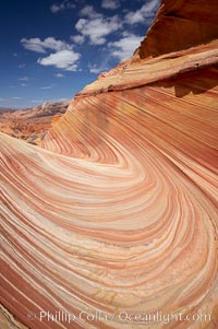 The Wave, an area of fantastic eroded sandstone featuring beautiful swirls, wild colors, countless striations, and bizarre shapes set amidst the dramatic surrounding North Coyote Buttes of Arizona and Utah.  The sandstone formations of the North Coyote Buttes, including the Wave, date from the Jurassic period. Managed by the Bureau of Land Management, the Wave is located in the Paria Canyon-Vermilion Cliffs Wilderness and is accessible on foot by permit only. USA, natural history stock photograph, photo id 20618