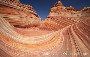 The Wave, an area of fantastic eroded sandstone featuring beautiful swirls, wild colors, countless striations, and bizarre shapes set amidst the dramatic surrounding North Coyote Buttes of Arizona and Utah.  The sandstone formations of the North Coyote Buttes, including the Wave, date from the Jurassic period. Managed by the Bureau of Land Management, the Wave is located in the Paria Canyon-Vermilion Cliffs Wilderness and is accessible on foot by permit only