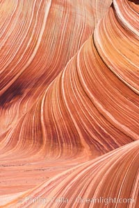 The Wave, an area of fantastic eroded sandstone featuring beautiful swirls, wild colors, countless striations, and bizarre shapes set amidst the dramatic surrounding North Coyote Buttes of Arizona and Utah.  The sandstone formations of the North Coyote Buttes, including the Wave, date from the Jurassic period. Managed by the Bureau of Land Management, the Wave is located in the Paria Canyon-Vermilion Cliffs Wilderness and is accessible on foot by permit only