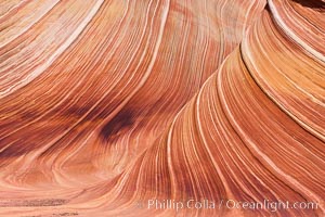 The Wave, an area of fantastic eroded sandstone featuring beautiful swirls, wild colors, countless striations, and bizarre shapes set amidst the dramatic surrounding North Coyote Buttes of Arizona and Utah.  The sandstone formations of the North Coyote Buttes, including the Wave, date from the Jurassic period. Managed by the Bureau of Land Management, the Wave is located in the Paria Canyon-Vermilion Cliffs Wilderness and is accessible on foot by permit only