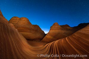 The Wave at Night, under a clear night sky full of stars.  The Wave, an area of fantastic eroded sandstone featuring beautiful swirls, wild colors, countless striations, and bizarre shapes set amidst the dramatic surrounding North Coyote Buttes of Arizona and Utah. The sandstone formations of the North Coyote Buttes, including the Wave, date from the Jurassic period. Managed by the Bureau of Land Management, the Wave is located in the Paria Canyon-Vermilion Cliffs Wilderness and is accessible on foot by permit only.