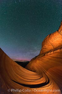 The Wave at Night, under a clear night sky full of stars.  The Wave, an area of fantastic eroded sandstone featuring beautiful swirls, wild colors, countless striations, and bizarre shapes set amidst the dramatic surrounding North Coyote Buttes of Arizona and Utah. The sandstone formations of the North Coyote Buttes, including the Wave, date from the Jurassic period. Managed by the Bureau of Land Management, the Wave is located in the Paria Canyon-Vermilion Cliffs Wilderness and is accessible on foot by permit only.