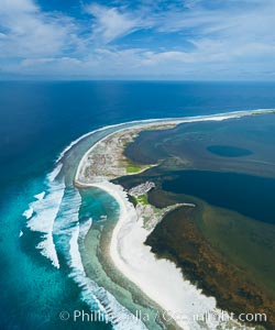 Waves break on the coral reef and wash ashore at Clipperton Island, aerial photo. Clipperton Island, a minor territory of France also known as Ile de la Passion, is a spectacular coral atoll in the eastern Pacific. By permit HC / 1485 / CAB (France)