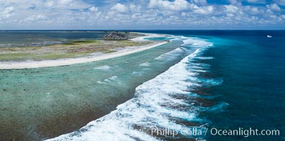 Waves break on the coral reef and wash ashore at Clipperton Island, aerial photo. Clipperton Island, a minor territory of France also known as Ile de la Passion, is a spectacular coral atoll in the eastern Pacific. By permit HC / 1485 / CAB (France)