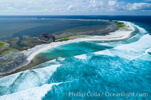Waves break on the coral reef and wash ashore at Clipperton Island, aerial photo. Clipperton Island, a minor territory of France also known as Ile de la Passion, is a spectacular coral atoll in the eastern Pacific. By permit HC / 1485 / CAB (France)