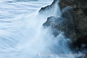 Waves wash over coast rocks, La Jolla, California