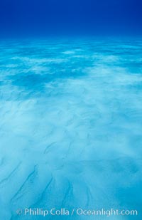 Sunlight spreads across broad sand plains, trochoidal patterns