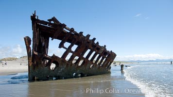 Wreck of the Peter Iredale, rusting away in the sand at the ocean's edge, Fort Stevens State Park, Oregon