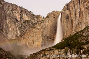 Upper Yosemite Falls by moonlight, viewed from Cooks Meadow. A very faint lunar rainbow (moonbow) can be seen to the left of Yosemite Falls, where the moon illuminates the spray of the falls. Yosemite Valley, Yosemite National Park, California