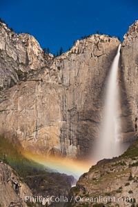 Upper Yosemite Falls and lunar rainbow, moonbow. A lunar rainbow (moonbow) can be seen to the left of Yosemite Falls, where the moon illuminates the spray of the falls, Yosemite National Park, California