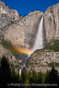 Upper Yosemite Falls and lunar rainbow, moonbow. A lunar rainbow (moonbow) can be seen to the left of Yosemite Falls, where the moon illuminates the spray of the falls.