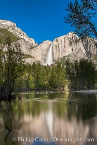 Yosemite Falls reflected in the Merced River, illuminated by moonlight, spring, Yosemite National Park, California