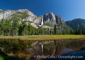 Yosemite Falls reflected in flooded meadow.  The Merced  River floods its banks in spring, forming beautiful reflections of Yosemite Falls, Yosemite National Park, California