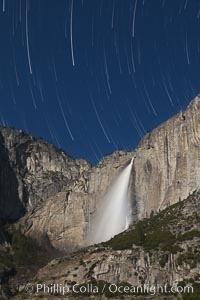 Yosemite Falls and star trails, at night, viewed from Cook's Meadow, illuminated by the light of the full moon, Yosemite National Park, California