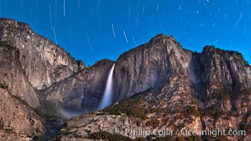 Yosemite Falls and star trails, night sky time exposure of Yosemite Falls waterfall in full spring flow, with star trails arcing through the night sky. Yosemite National Park, California, USA, natural history stock photograph, photo id 26853