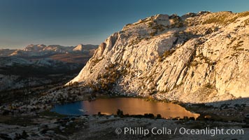 Fletcher Peak is reflected in Vogelsang Lake at sunset viewed from near summit of Vogelsang Peak.