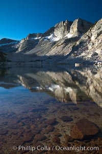 Cathedral Range peaks reflected in the still waters of Townsley Lake at sunrise, Yosemite National Park, California