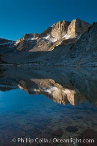 Cathedral Range peaks reflected in the still waters of Townsley Lake at sunrise, Yosemite National Park, California