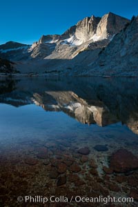 Cathedral Range peaks reflected in the still waters of Townsley Lake at sunrise, Yosemite National Park, California