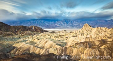 Zabriskie Point sunrise, clouds blurred by long time exposure, Death Valley National Park, California.