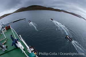 Zodiac boats, are lowered into the ocean from the ship M/V Polar Star in preparation for a day exploring New Island in the Falklands.