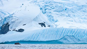 Zodiac cruising in Antarctica.  Tourists enjoy the pack ice and towering glaciers of Cierva Cove on the Antarctic Peninsula