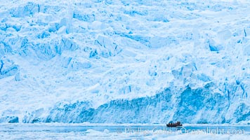 Zodiac cruising in Antarctica.  Tourists enjoy the pack ice and towering glaciers of Cierva Cove on the Antarctic Peninsula