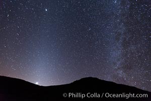 Zodiacal light and Milky Way over Death Valley.  Zodiacal light is a faint diffuse light seen along the plane of the ecliptic in the vicinity of the setting or rising sun, caused by sunlight scattered off space dust in the zodiacal cloud, Racetrack Playa, Death Valley National Park, California