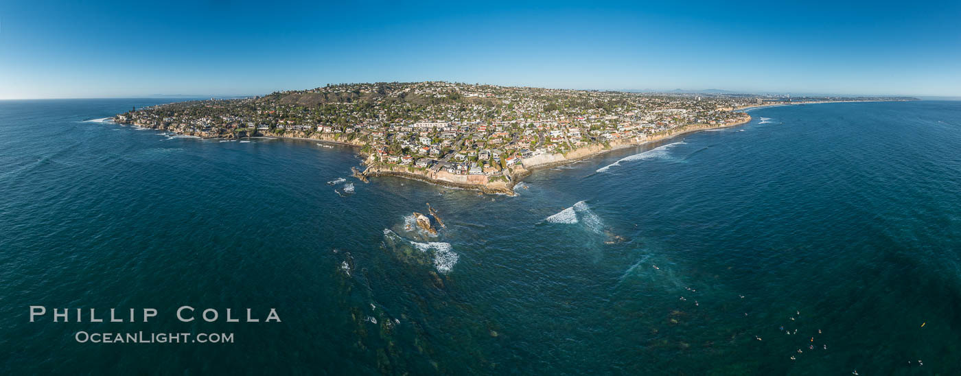 Aerial Panoramic Photo of Bird Rock and La Jolla Coast, with surfers in the waves.  Pacific Beach and Mission Beach are to the far right (south).  La Jolla's Mount Soledad rises in the center.  The submarine reefs around Bird Rock are visible through the clear water. This extremely high resolution panorama will print 80 inches high by 200 inches wide. California, USA, natural history stock photograph, photo id 30778