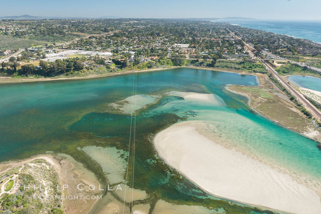 Aerial photo of Batiquitos Lagoon, Carlsbad. The Batiquitos Lagoon is a coastal wetland in southern Carlsbad, California. Part of the lagoon is designated as the Batiquitos Lagoon State Marine Conservation Area, run by the California Department of Fish and Game as a nature reserve. Callifornia, USA, natural history stock photograph, photo id 30568