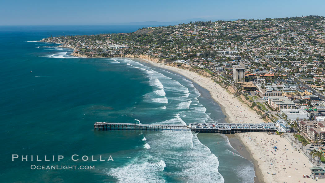 Aerial Photo of Crystal Pier, 872 feet long and built in 1925, extends out into the Pacific Ocean from the town of Pacific Beach. Mission Bay and downtown San Diego are seen in the distance. California, USA, natural history stock photograph, photo id 30683