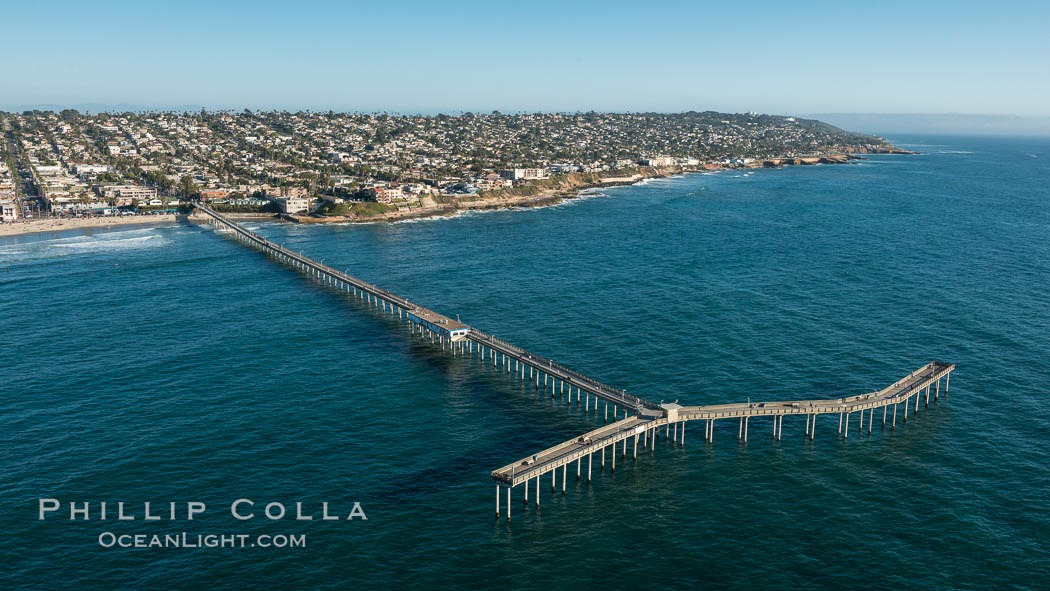 Aerial Photo of Ocean Beach Pier. Ocean Beach Pier, also known as the OB Pier or Ocean Beach Municipal Pier, is the longest concrete pier on the West Coast measuring 1971 feet (601 m) long. Sunset Cliffs and Point Loma extend off to the south., natural history stock photograph, photo id 30753