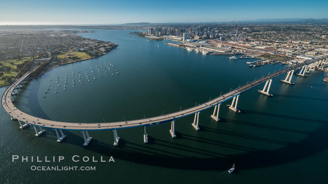 Aerial Photo of San Diego Coronado Bridge, known locally as the Coronado Bridge, links San Diego with Coronado, California. The bridge was completed in 1969 and was a toll bridge until 2002. It is 2.1 miles long and reaches a height of 200 feet above San Diego Bay. Coronado Island is to the left, and downtown San Diego is to the right in this view looking north., natural history stock photograph, photo id 30763