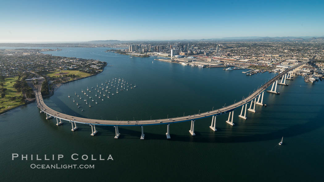 Aerial Photo of San Diego Coronado Bridge, known locally as the Coronado Bridge, links San Diego with Coronado, California. The bridge was completed in 1969 and was a toll bridge until 2002. It is 2.1 miles long and reaches a height of 200 feet above San Diego Bay. Coronado Island is to the left, and downtown San Diego is to the right in this view looking north., natural history stock photograph, photo id 30761